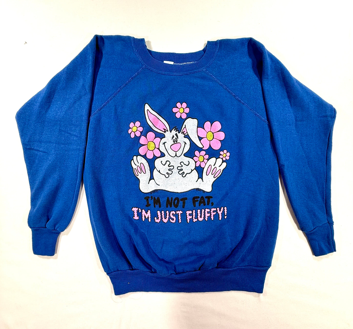 Vintage Raglan Crewneck Sweatshirt 88s Blue Size L featuring a cartoon graphic of a white bunny surrounded by pink flowers, with the text 'I'M NOT FAT. I'M JUST FLUFFLY!' printed below.