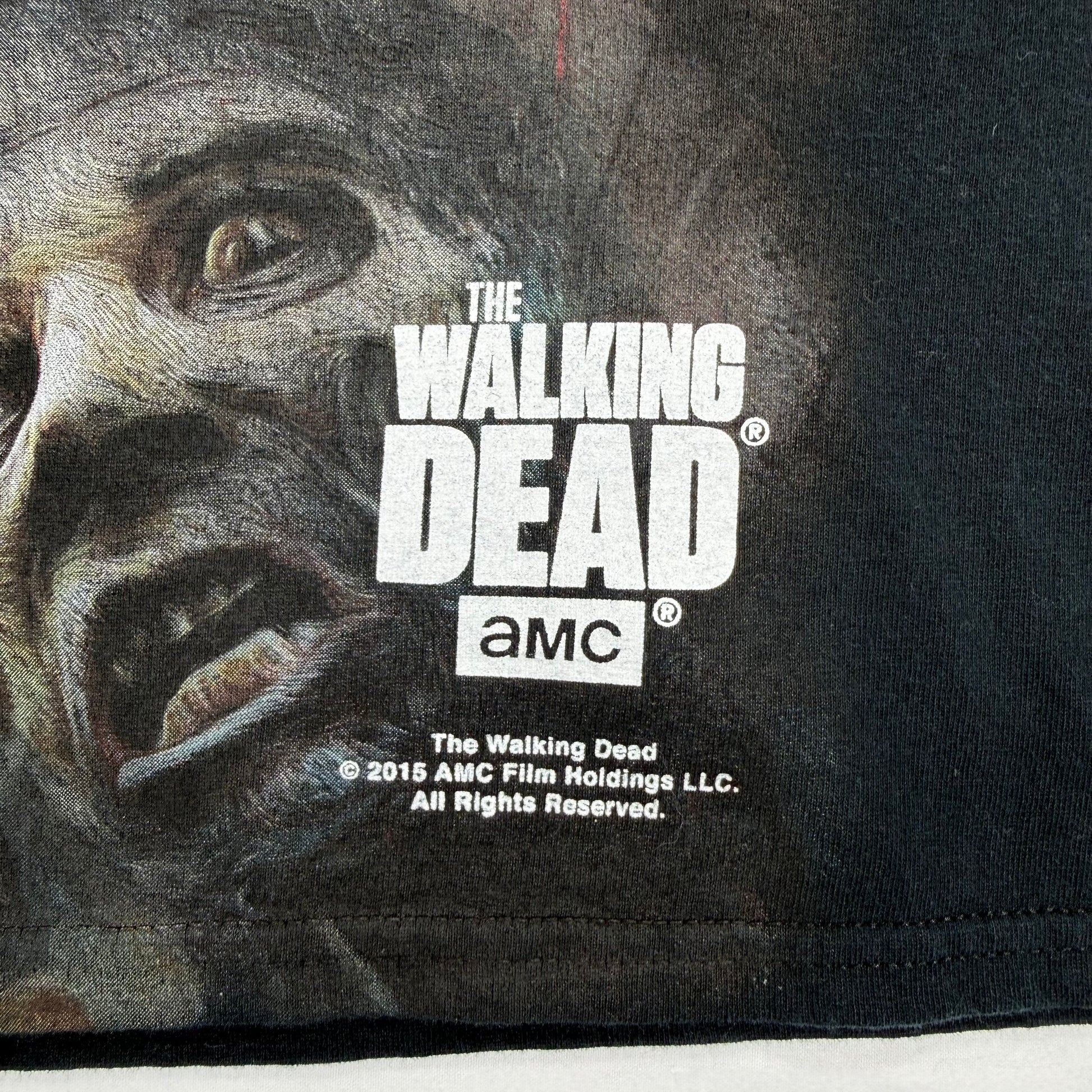 Black t-shirt with 'The Walking Dead' logo and zombie graphic, featuring AMC branding.